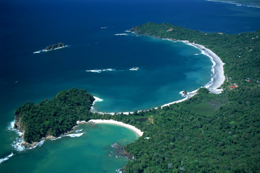 A breathtaking aerial shows Manuel Antonio's twin beaches and lush rainforest hugging the Pacific coast.  