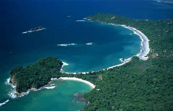 A breathtaking aerial shows Manuel Antonio's twin beaches and lush rainforest hugging the Pacific coast.  