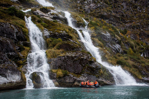 Coastal waterfalls crash into the sea