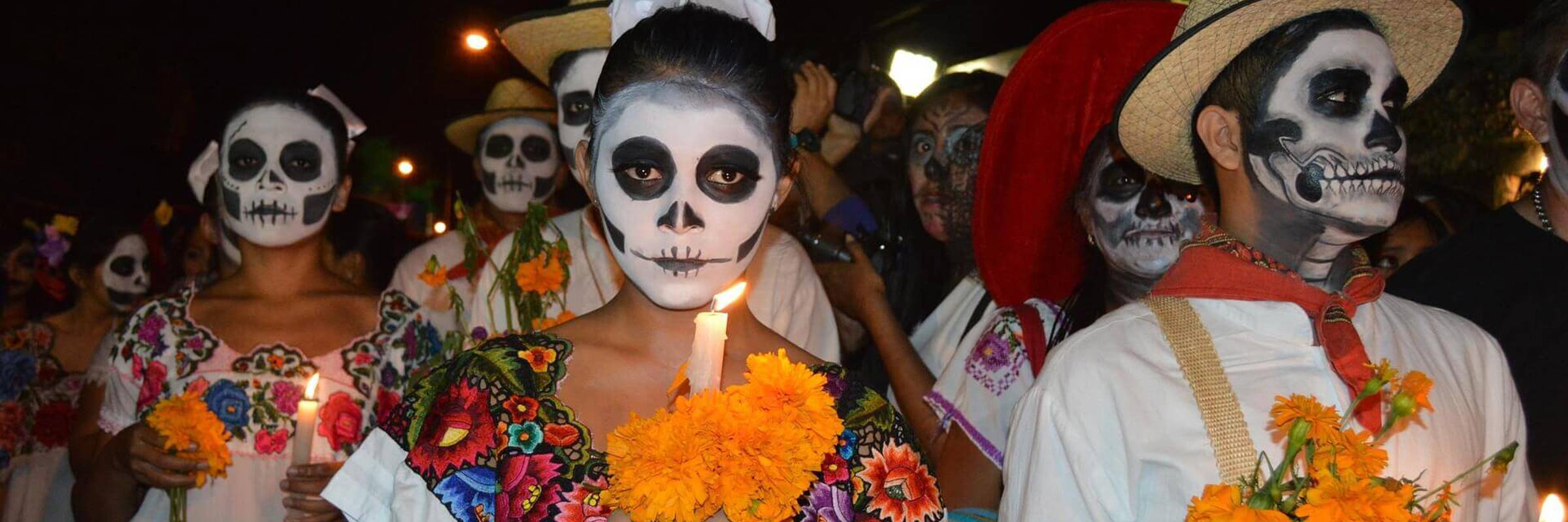 Traditional Day of the Dead parade with face paint, marigolds, and colourful attire honoring Mexican ancestors. 