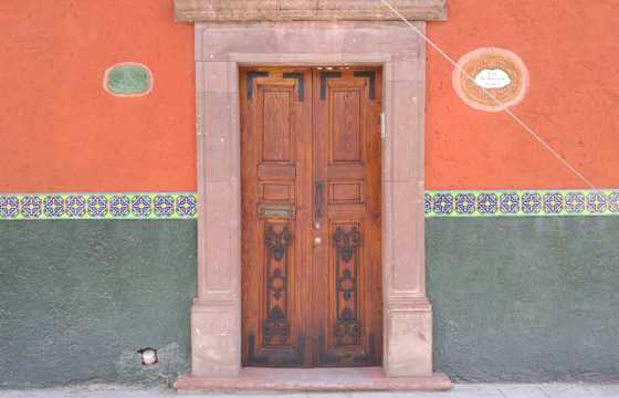 A beautiful decorated colonial-style wooden door in Mexico. 