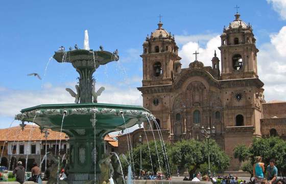 Historic Plaza de Armas in Cusco with the Cathedral and central fountain. 