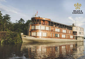 The Delfin II luxury riverboat cruising through the Amazon rainforest from Iquitos, Peru. 