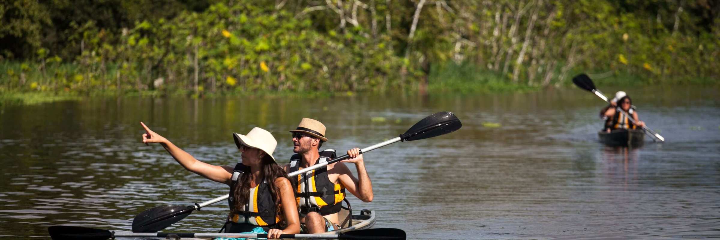 Guests paddle through lush rainforest waterways on a guided kayaking adventure in the Amazon. 