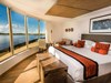 Expedition cruise in the stunning corner suite with expansive views of the rainforest