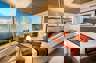 Expedition cruise in the stunning corner suite with expansive views of the rainforest