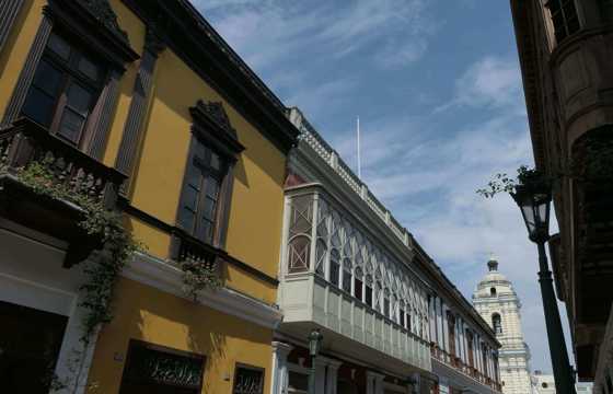 Charming balconies and blood colours line a colonial-era street in Lima's historic center. 