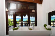 Luxury hotel suite in Riviera Maya, Mexico, with panoramic window and ocean views. 