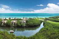 Aerial view of Fairmont Mayakoba Resort in Riviera Maya showing mangroves, water canals, villas, and the Caribbean Sea. 