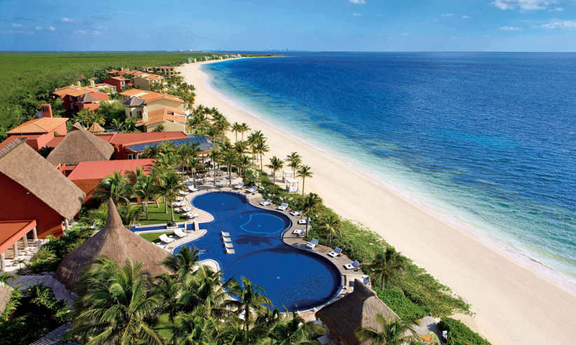 Aerial view of the Large swimming pool at Zoetry Paraiso de la Bonita Resort, Yucatan, with lush gardens and beachfront location. 