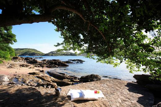 Shaded rocky beach at Insolito Hotel in Buzios, Brazil , offering a peaceful and scenic seaside retreat. 