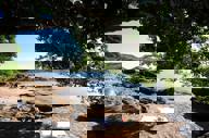Shaded rocky beach at Insolito Hotel in Buzios, Brazil , offering a peaceful and scenic seaside retreat.