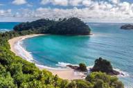 Crystal-clear waters and golden sands curve into a perfect bay at Manuel Antonio, Costa Rica. 