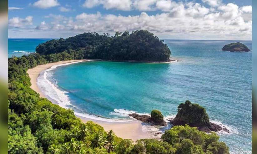 Crystal-clear waters and golden sands curve into a perfect bay at Manuel Antonio, Costa Rica. 