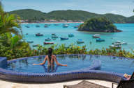 Infinity pool at Villa d'Este, Buzios, with panoramic views over Armacao Bay and anchored boats. 