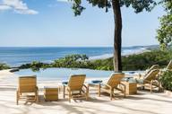 Lounge chairs line an infinity pool overlooking the Pacific, offering a tranquil setting at Lagarta Lodge. 