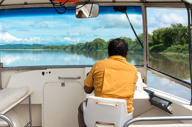 A local guide navigates through the wetlands of Guanacaste, offering a glimpse into Costa Rica's diverse ecosystems. 