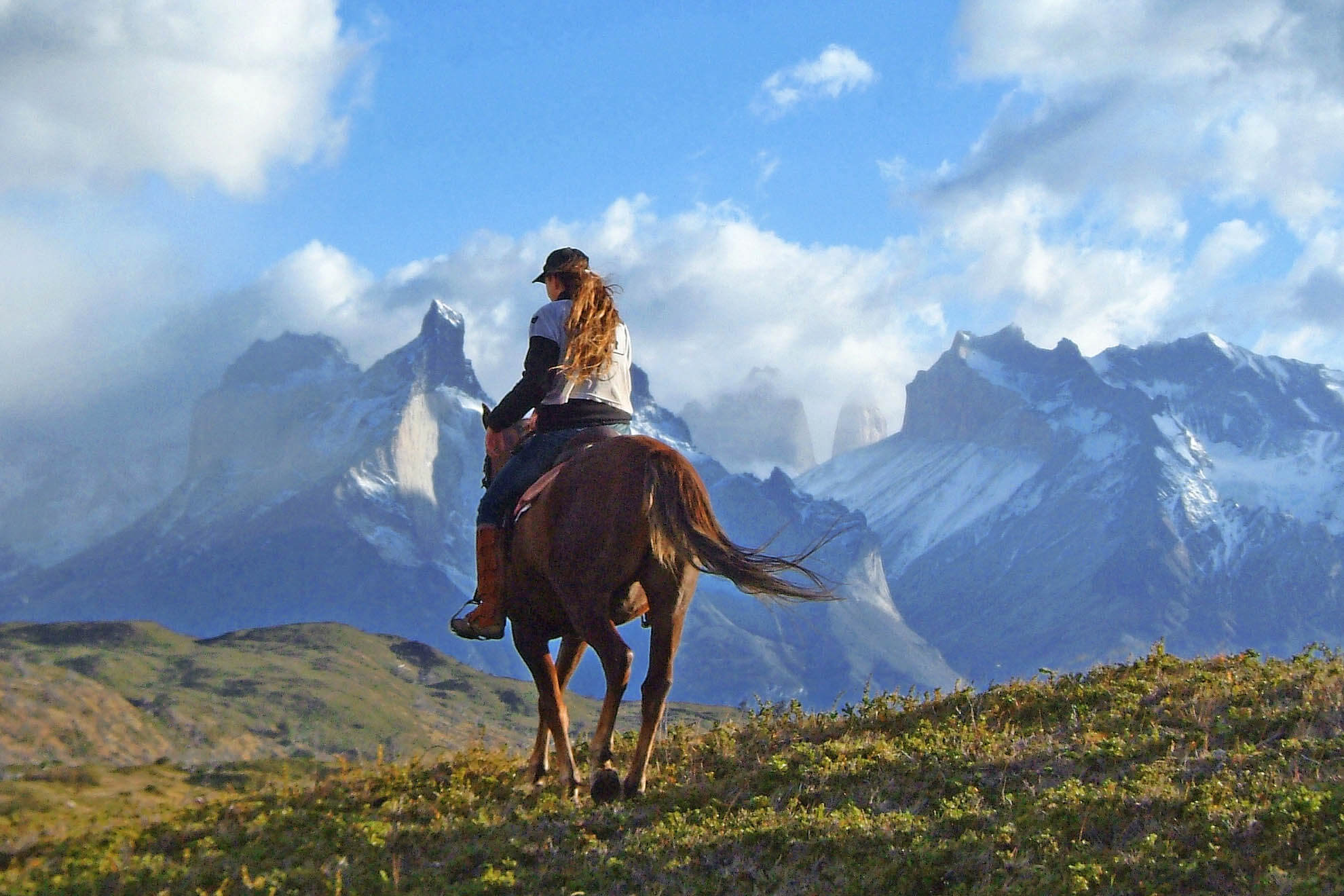 Horseback ride to Los Cuernos in Torres del Paine, with view of Patagonia peaks in Chilean national park. 