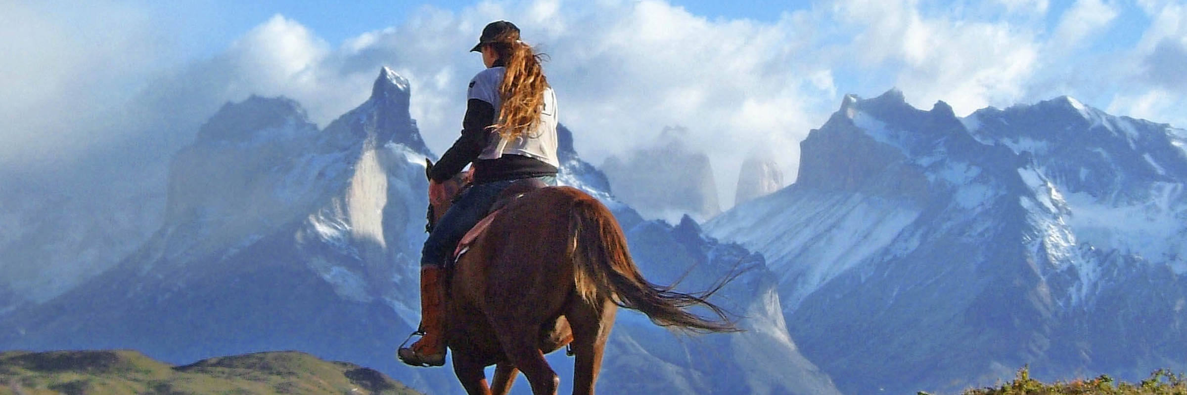 Horseback ride to Los Cuernos in Torres del Paine, with view of Patagonia peaks in Chilean national park. 