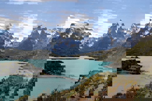 Turquoise lake with dramatic mountain peaks in Torres del Paine National Park, a scenic gem of Chilean Patagonia. 