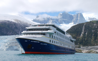 The Stella Australis cruise ship sails past icy waters and snow-covered peaks in the remote glacial fjords of Patagonia. 