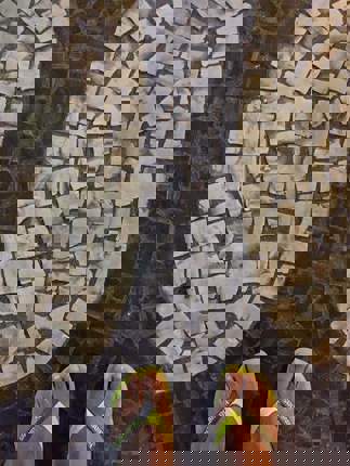 Iconic black and white mosaic sidewalk pattern of Copacabana in Rio de Janeiro. 