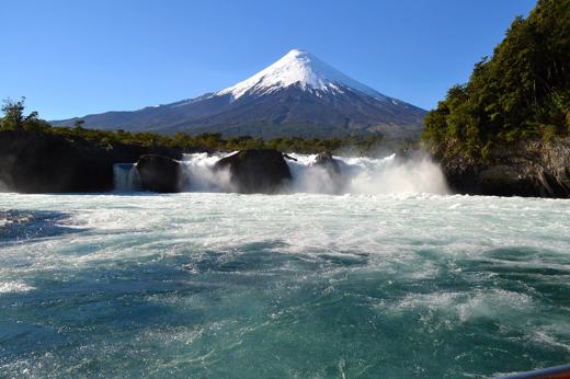 Osorno Volcano rises behind the Petrohue Falls in Chile's Lake District, a highlight of northern Patagonia's natural scenery. 