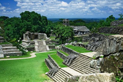 View of the ancient Mayan temples and ruins at Palenque, surrounded by jungle in Chiapas, Mexico. 