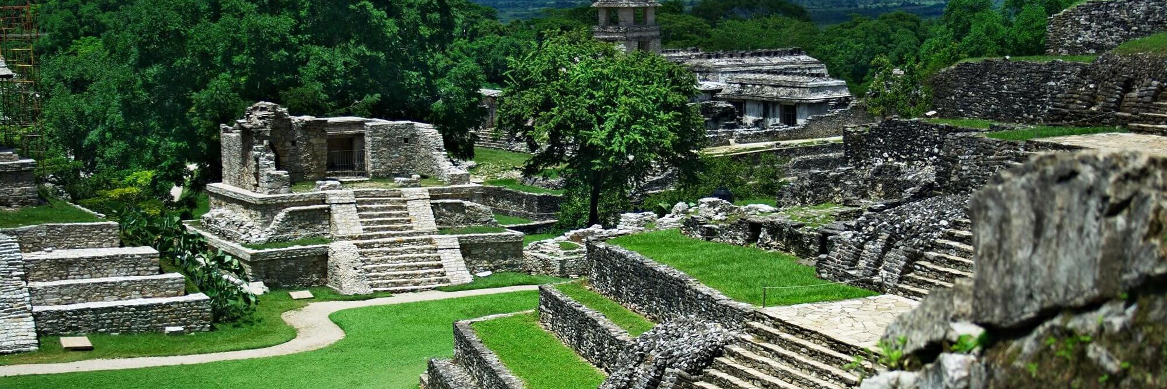 View of the ancient Mayan temples and ruins at Palenque, surrounded by jungle in Chiapas, Mexico. 