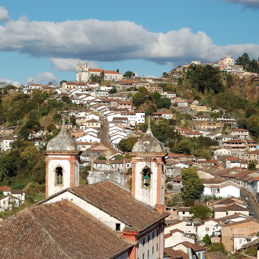 Panoramic view of Ouro Preto with colonial rooftops and historic churches nestled in the hills of Minas Gerais, Brazil. 