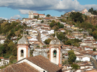 Panoramic view of Ouro Preto with colonial rooftops and historic churches nestled in the hills of Minas Gerais, Brazil. 