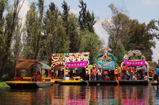 Colorful trajineras (boats) at the Xochimilco Floating Gardens in Mexico City, a popular UNESCO World Heritage site. 