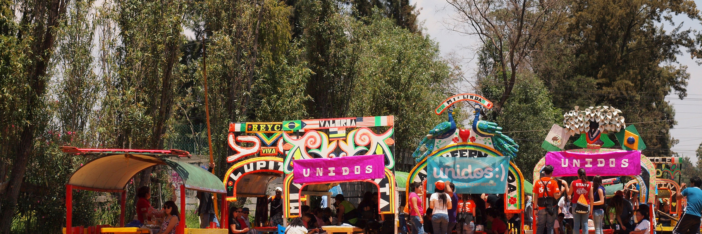 Colorful trajineras (boats) at the Xochimilco Floating Gardens in Mexico City, a popular UNESCO World Heritage site. 