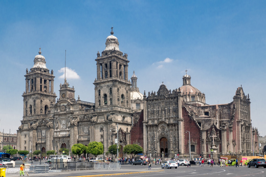  Front view of the Mexico City Metropolitan Cathedral on the Zocalo, featuring baroque and neoclassical architecture. 