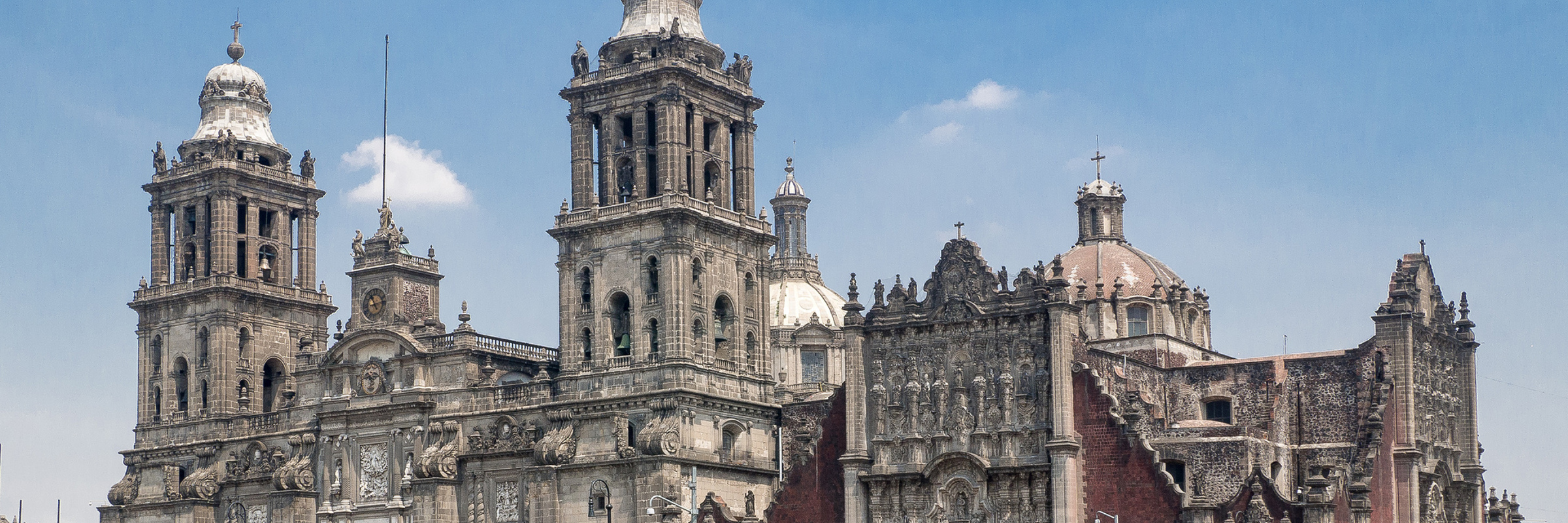  Front view of the Mexico City Metropolitan Cathedral on the Zocalo, featuring baroque and neoclassical architecture. 