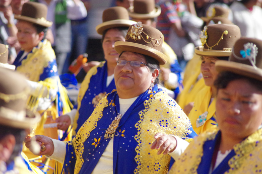 Women in vibrant Andean attire parade through Cusco during the Virgen Natividad celebration. 