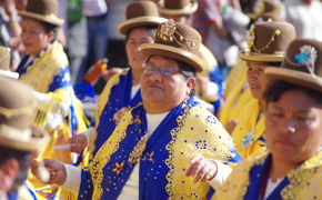 Women in vibrant Andean attire parade through Cusco during the Virgen Natividad celebration. 
