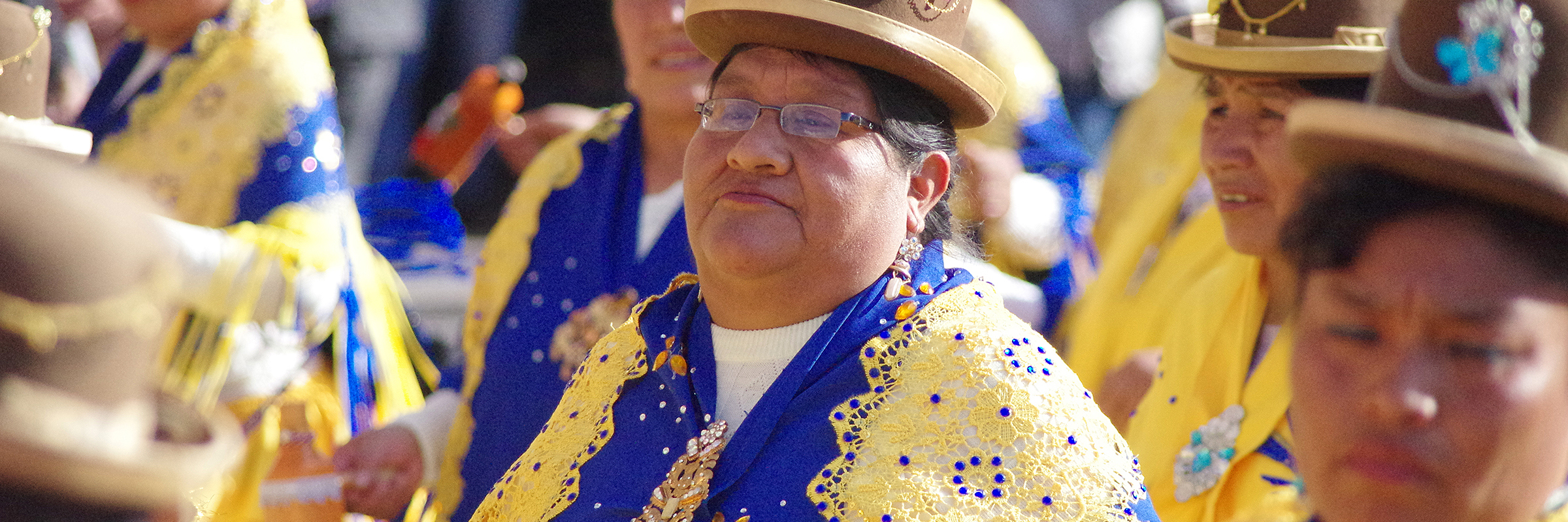 Women in vibrant Andean attire parade through Cusco during the Virgen Natividad celebration. 