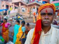 India- Local man in Varanasi at the ghats, where pilgrims gather for rituals by the sacred Ganges River. 