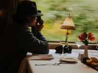 Passenger enjoying scenic views from the dining car on the Hiram Bingham train. 