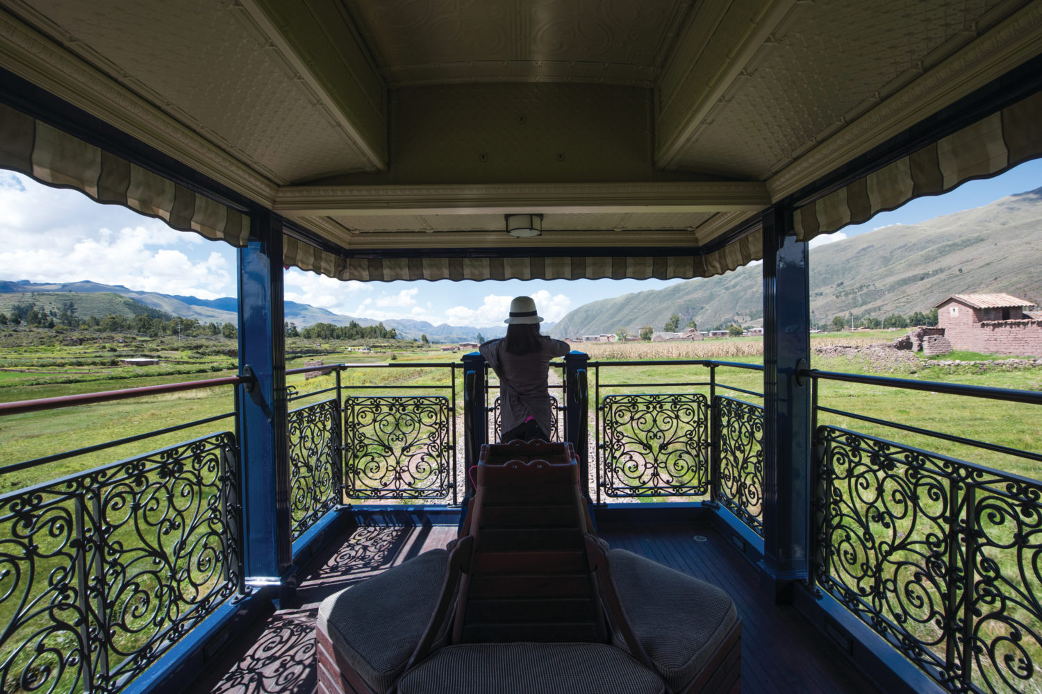 The open-air observation deck of the Belmond Andean Explorer offers panoramic views of the Peruvian highlands along the luxury rail route. 