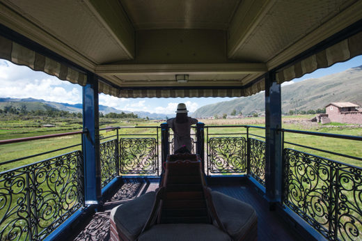 The open-air observation deck of the Belmond Andean Explorer offers panoramic views of the Peruvian highlands along the luxury rail route. 