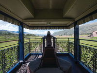 The open-air observation deck of the Belmond Andean Explorer offers panoramic views of the Peruvian highlands along the luxury rail route. 