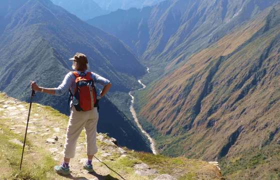 Hiker on the Inca overlooking Andes mountains near Machu Picchu, Peru adventure trek. 