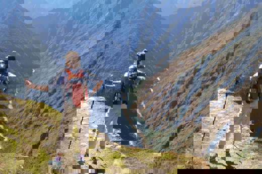 Hiker on the Inca overlooking Andes mountains near Machu Picchu, Peru adventure trek. 