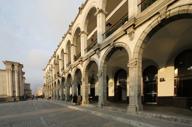 Colonial stone arches and shaded walkways of Casa Andina Select hotel in the heart of historic Arequipa, Peru. 