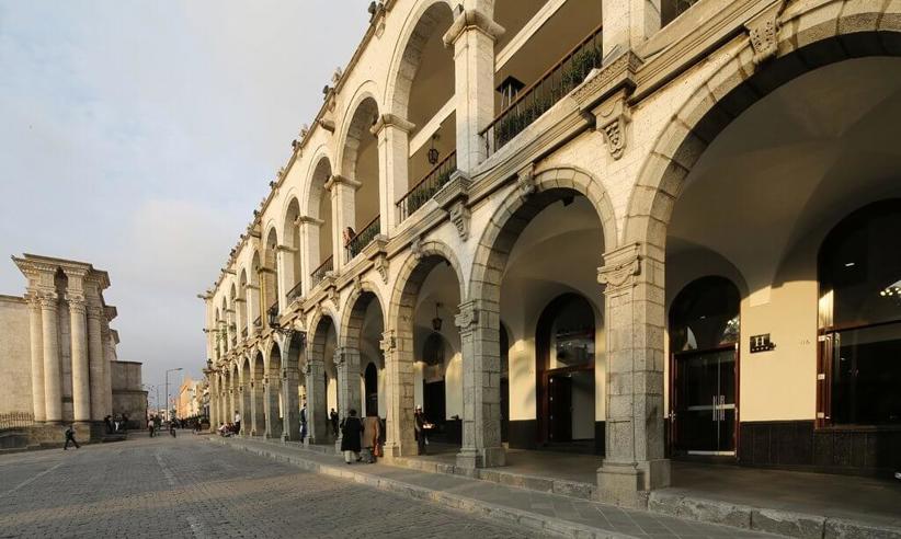 Colonial stone arches and shaded walkways of Casa Andina Select hotel in the heart of historic Arequipa, Peru. 