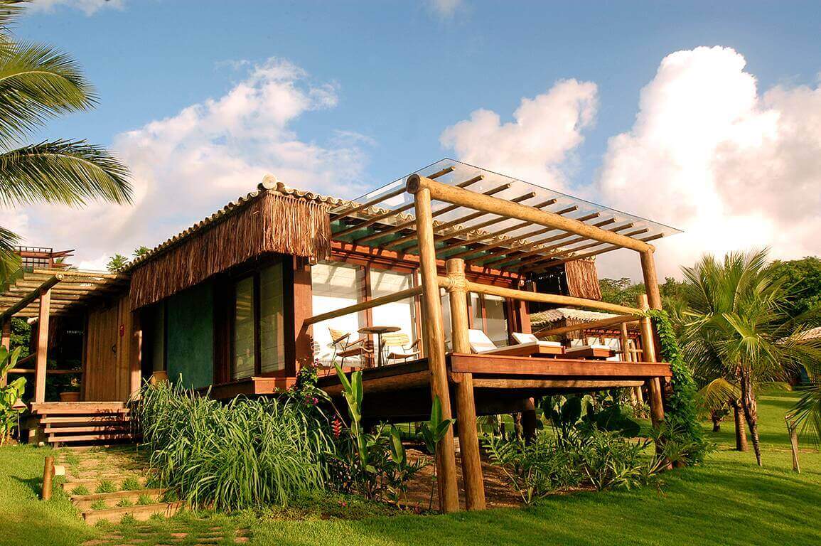  Eco-style luxury bungalow with palm-fringed garden and ocean-view terrace in Praia do Forte, Bahia, Brazil. 