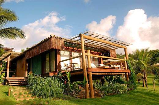  Eco-style luxury bungalow with palm-fringed garden and ocean-view terrace in Praia do Forte, Bahia, Brazil. 