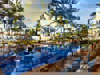 Palm trees and luxury pool by the beach